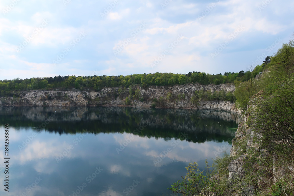 Obraz premium Zalew Zakrzówek - an artificial reservoir in Krakow in Zakrzówek. It was created in 1992 after the flooding of an old limestone quarry. It consists of two reservoirs, connected by an isthmus