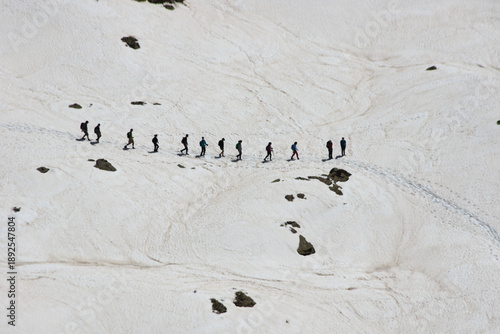 Quadro em tela Hikers in a snowy pathway in the Alps