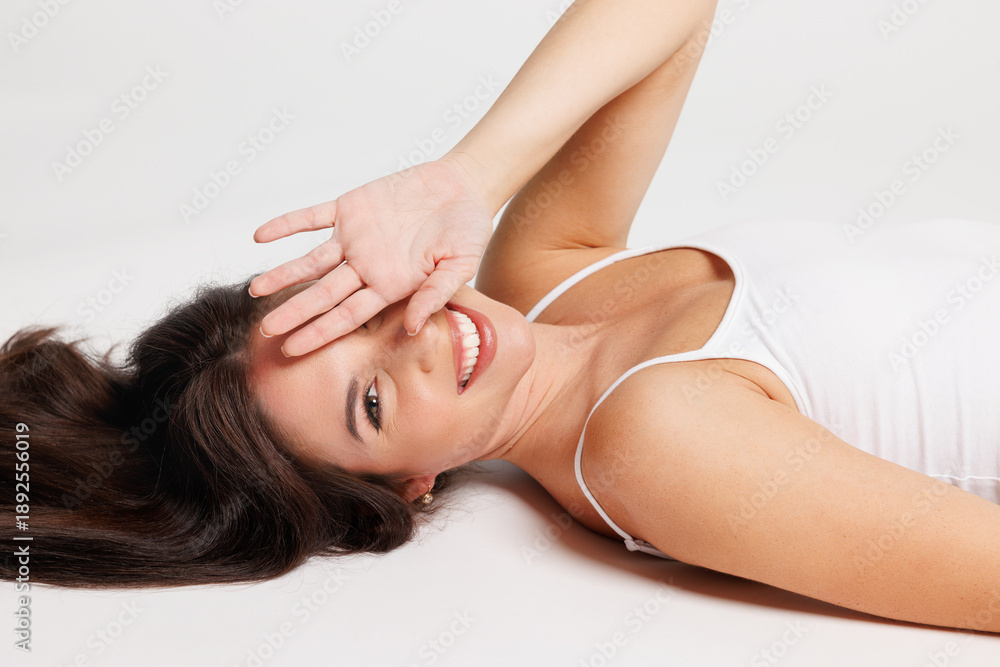 Obraz premium Smiling young woman with slim fit body perfect skin wear lingerie underwear she put hands on pretty face isolated on plain solid white background studio portrait Skin care cosmetic procedures concept