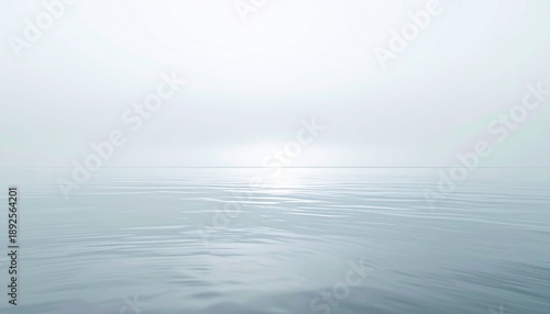 Serene ocean waters reflecting a soft, misty atmosphere in a calm seascape viewed from a low vantage point