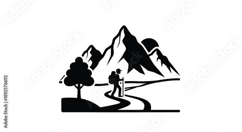 A lone hiker walks a winding path near silhouetted mountains