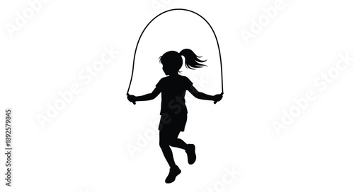 Silhouette of a young girl joyfully jumping rope in mid air