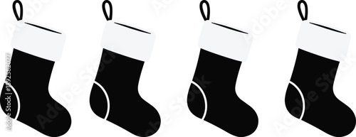 Four black and white Christmas stockings arranged in a row holiday festive