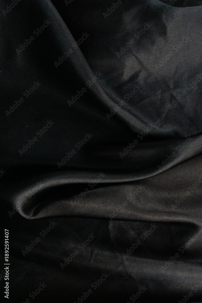 Fototapeta premium black silk texture background dark wavy surface elegant cloth fabric folds luxury material drapery smooth textile backdrop with copy space for banner design concept of fashion, interior design, luxury