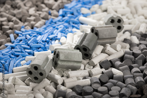 Quadro su tela Detailed close-up of diverse nano catalysts for oil/gas, showing industrial pellets, cylinders, and multi-channel extrusions in gray, white, and