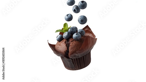 A floating chocolate muffin isolated on a pure white background, realistic food photography. The muffin has a cracked chocolate top, topped with fresh blueberries and a small mint leaf. Several bluebe