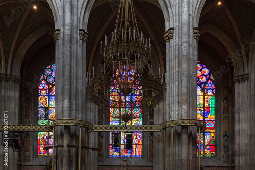 Chandelier, columns and stained glass windows in the 1879 Neo-Gothic Votivkirche (Votive Church), Vienna, Austria