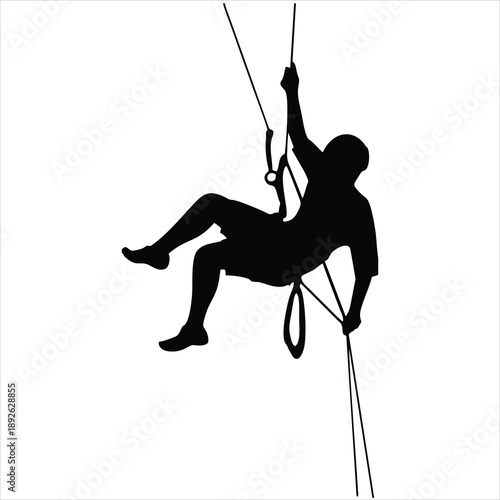 Rock climber rappelling down rope.