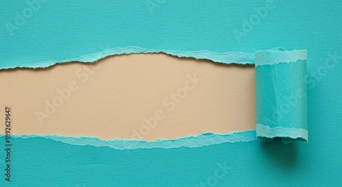 A torn teal paper revealing a beige background with a curled edge