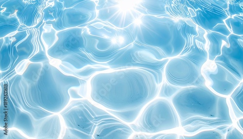 Overhead view of clear, rippled water with sun reflections creating bright highlights