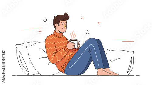 Young caucasian male relaxing with coffee on cushions in cozy sweater