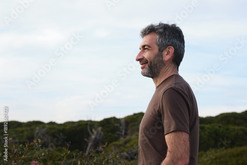 Mature man looking away with thoughtful expression outdoors