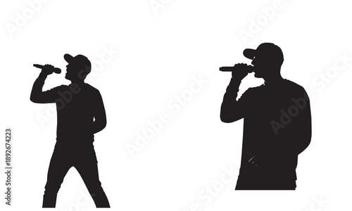 Silhouette of a man singing into a microphone on stage, performer