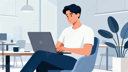 A man is sitting in a chair with a laptop in front of him. He is typing on the laptop and he is focused on his work. The room is well-lit and has a modern, professional feel