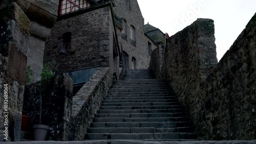 Mont-Saint-Michel, Normandy, 08-24-2024. Medieval stone staircase inside the walls of Mont Saint Michel. Video 4K