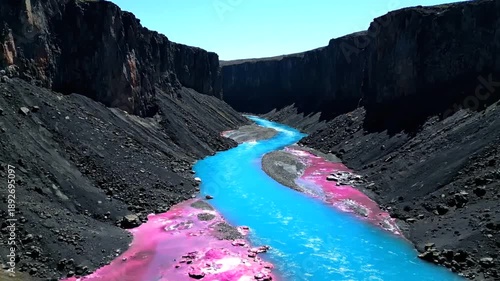 Stunning aerial view of a vibrant river flowing through a canyon.