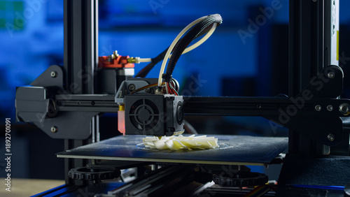Photos A 3D printer creates a plastic prototype using additive manufacturing in a clean and organized workspace with no human presence