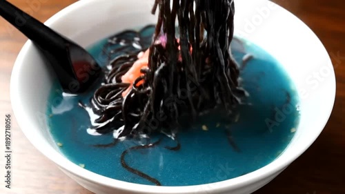 Delicious Japanese Ramen Noodles in a Beautiful White Bowl with Chopsticks.