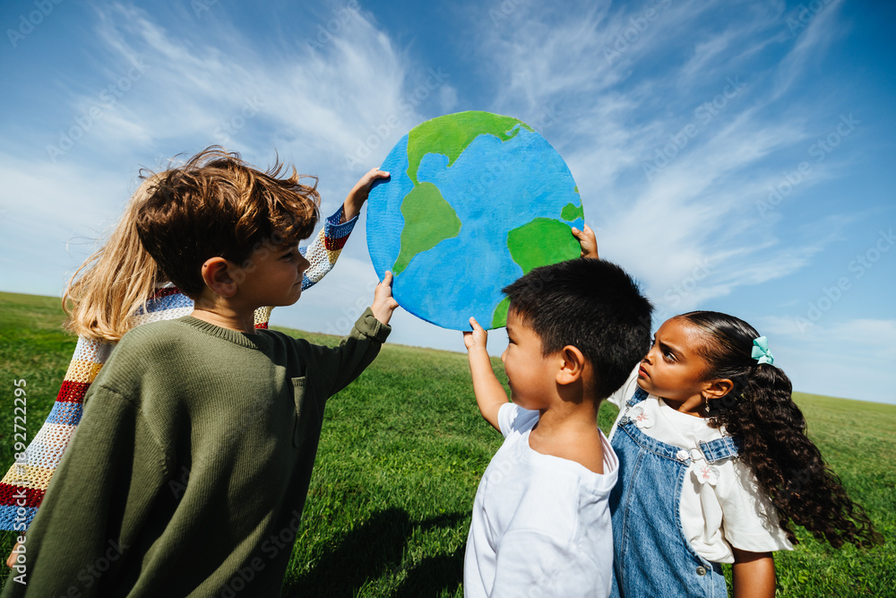 Fototapeta premium Kids holding globe to promote environmental awareness