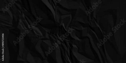 Dark black crumpled paper texture background. black crumpled and top view textures can be used for background of text or any contents.