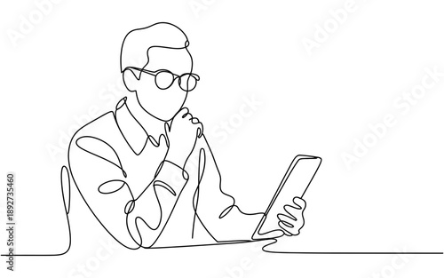 Man in glasses focused on a tablet, contemplating while using digital technology