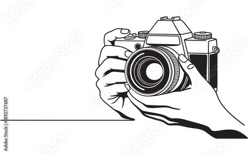 A hand holding a classic slr camera, ready to capture a photographic moment