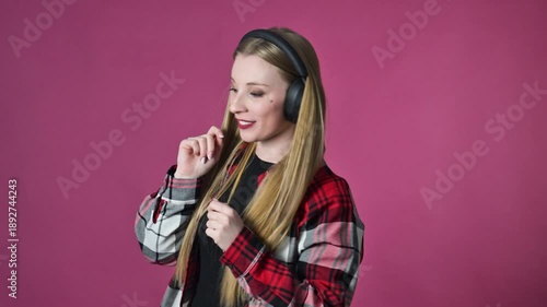 Portrait of dancing young woman with headphones, slow motion