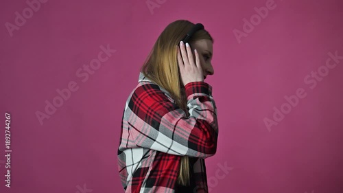 Portrait of dancing young woman with headphones, slow motion