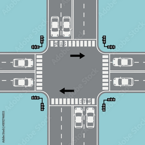 Aerial view of a busy four-way intersection with traffic lights and cars