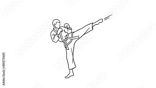 Martial artist performing high kick in karate uniform
