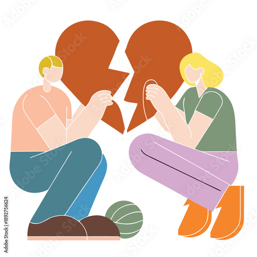 A man and a woman are holding a broken heart. The man is kneeling down and the woman is sitting. .