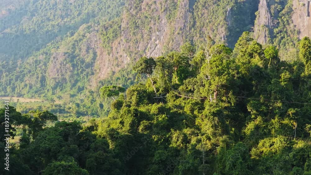 custom made wallpaper toronto digitalParagliders fly over silhouetted mountains in Laos during golden sunset, creating serene and adventurous atmosphere
