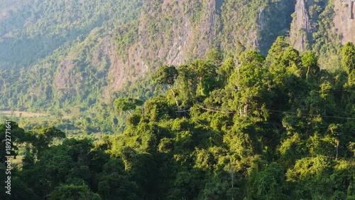 Wallpaper Mural Paragliders fly over silhouetted mountains in Laos during golden sunset, creating serene and adventurous atmosphere Torontodigital.ca