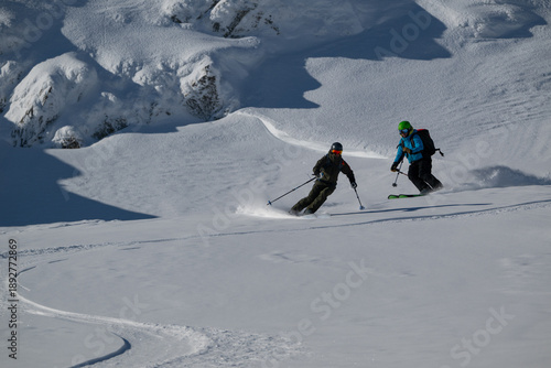 Fotografie Two Skiers Descend a Snowy Alpine Slope in Off-Piste Freeride Adventure