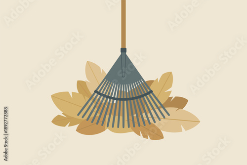 Rake on a Pile of Fallen Autumn Leaves, seasonal garden work concept