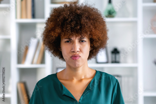 Young offended African American woman pouts lips to show displeasure or resentment