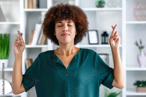 fingers crossed by black woman. Hope, luck and wishing young female doing wish hand gesture worried, miracle and worried