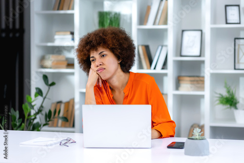 Canvastavla Bored young woman sit at home office table look in distance unable to work at laptop, exhausted girl student feel unmotivated unwilling to study, distracted taking break