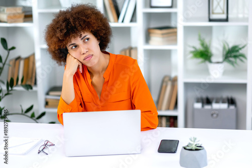 Konstfotografi Bored young woman sit at home office table look in distance unable to work at laptop, exhausted girl student feel unmotivated unwilling to study, distracted taking break