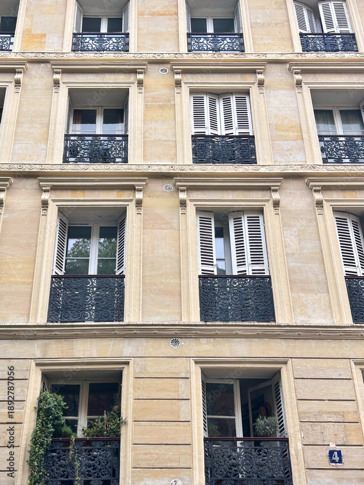Fototapeta premium Facades of beautiful old buildings with French windows and shutters, Paris, France.