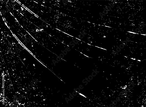 Monochrome grunge texture with radiating white scratches and distressed dusty particles on a black surface.