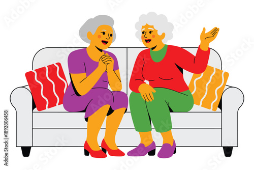 Two elderly women sitting on a couch and chatting comfortably together