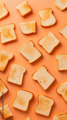 Crispy golden toasted bread slices arranged in a vibrant, playful pattern on an orange background