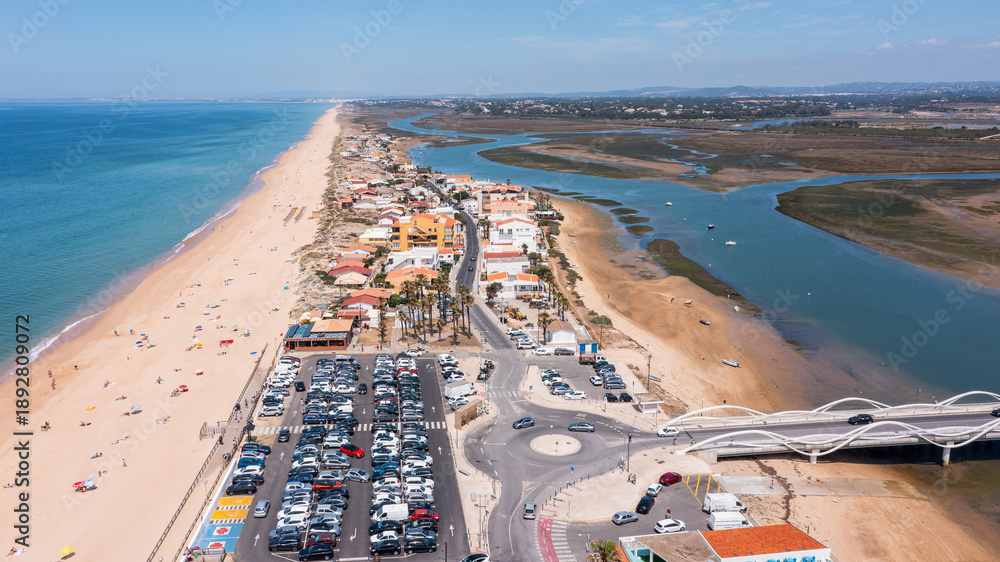 custom made wallpaper toronto digitalAerial view of Praia de Faro showing the sandy beach, surrounding buildings, river, and parked cars. Clear skies highlight the coastal landscape of Ria Formosa