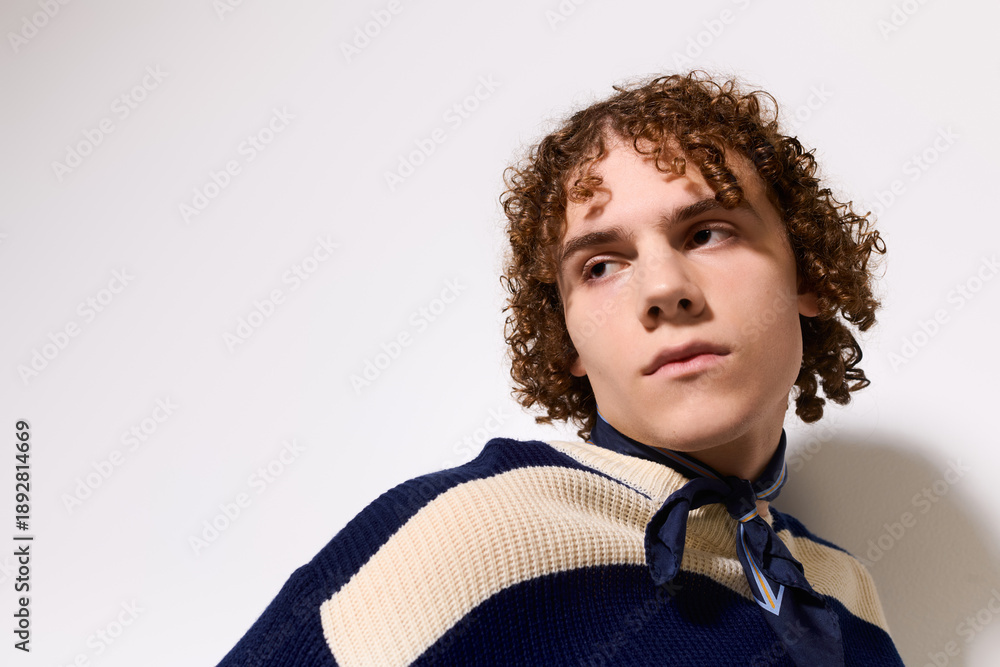 Fototapeta premium Stylish teenager exuding confidence in a trendy outfit in a bright setting