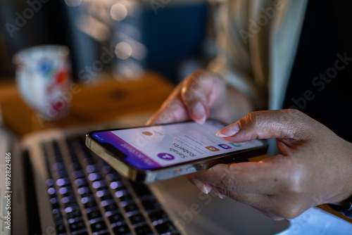Person using mobile payment app at home office desk