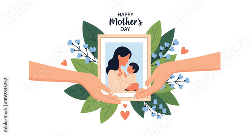 Hands holding a framed photo of a mother and child surrounded by green leaves and blue flowers for a happy mothers day message.