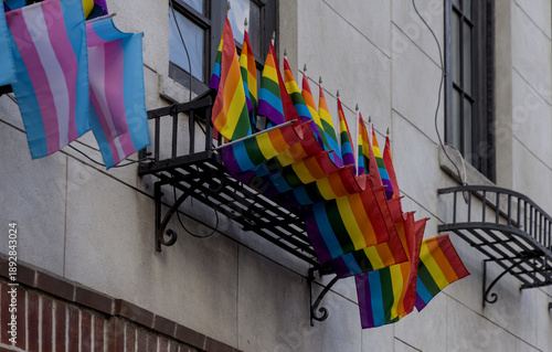 rainbow flags waving in window (symbol gay pride month celebration) west village manhattan new york city trans queer lesbian solidarity lifestyle alternative lifestyles advocacy struggle equality lgbt