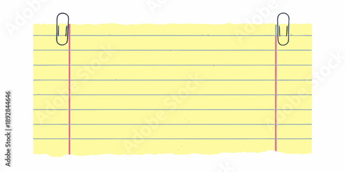 Yellow notepad paper secured with two silver metal paper clips