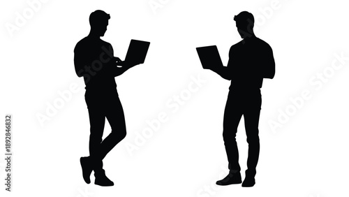 Two silhouetted figures using laptops one standing and one slightly reclined